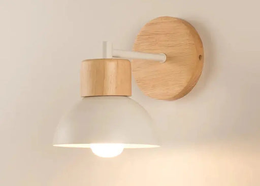 Wooden wall lamp with a light bulb on a plain background