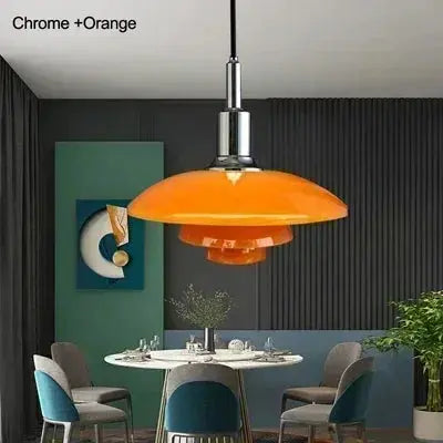 Orange pendant light in a modern dining room with gray walls and colorful chairs.